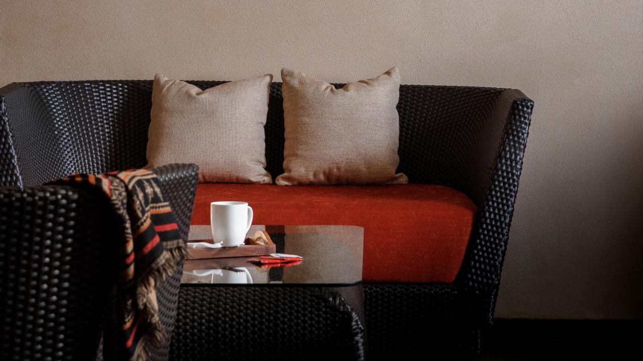 The Panoramic Getaway Hotel Munnar Bagian luar foto A rattan sofa