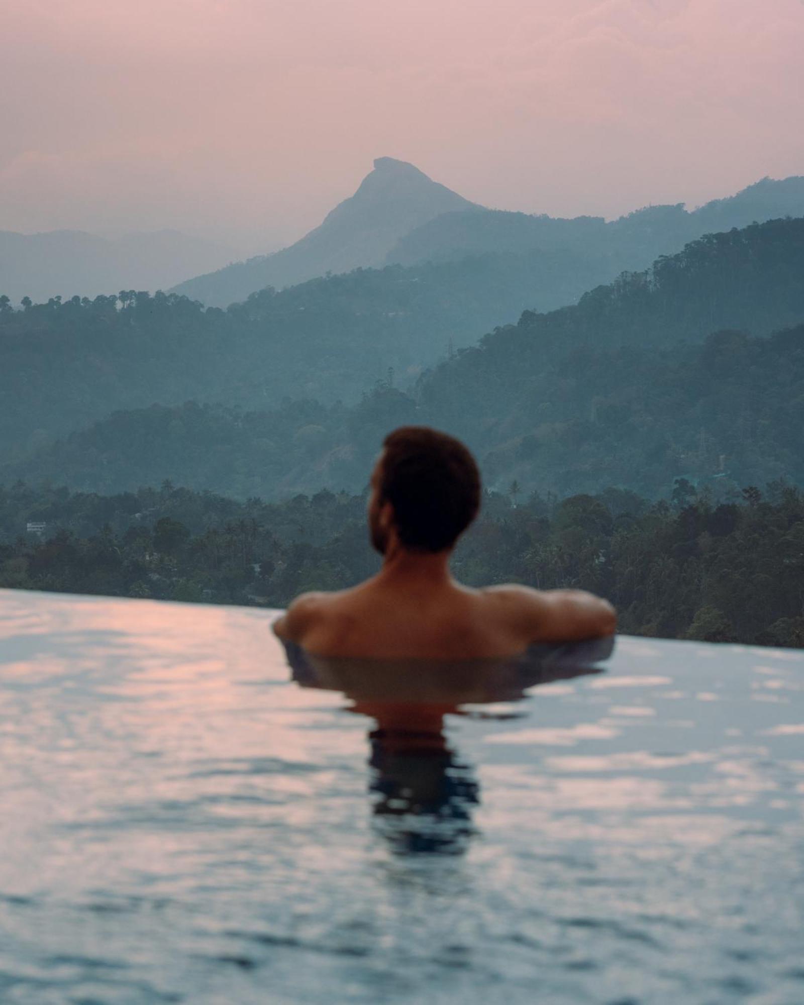 The Panoramic Getaway Hotel Munnar Bagian luar foto A man in a swimming pool